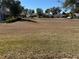 View of large community yard area in a neighborhood of homes under a clear blue sky at 11120 Sw 71St Terrace Rd, Ocala, FL 34481