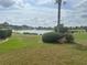 Expansive backyard with picturesque lake views and well-manicured lawn at 12453 Se 93Rd Court Rd, Summerfield, FL 34491