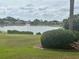 Scenic backyard view featuring a serene lake and lush landscaping at 12453 Se 93Rd Court Rd, Summerfield, FL 34491