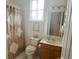 Bathroom featuring shower, toilet, vanity, and window at 12453 Se 93Rd Court Rd, Summerfield, FL 34491