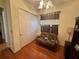 Bedroom featuring futon, window, closet, and wood floors at 12453 Se 93Rd Court Rd, Summerfield, FL 34491