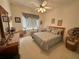 Cozy bedroom featuring a queen bed, bedside table with lamp, and natural light at 12453 Se 93Rd Court Rd, Summerfield, FL 34491