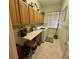 Efficient laundry room features lots of cabinet space and convenient folding table at 12453 Se 93Rd Court Rd, Summerfield, FL 34491