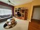 Comfortable living room with a sofa, entertainment center, and ceiling fan for relaxed living at 12453 Se 93Rd Court Rd, Summerfield, FL 34491