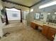Spacious bathroom featuring a tub, glass-enclosed shower, and dual vanities for convenience at 12453 Se 93Rd Court Rd, Summerfield, FL 34491