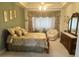 Inviting bedroom featuring a cozy bed, dresser, and soft lighting for a tranquil atmosphere at 12453 Se 93Rd Court Rd, Summerfield, FL 34491