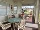 Enclosed sunroom offers a relaxing space with comfortable seating at 12453 Se 93Rd Court Rd, Summerfield, FL 34491