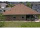 Aerial view of the home's back exterior, with a screened lanai and well-maintained lawn at 13196 Se 86Th Cir, Summerfield, FL 34491