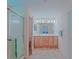 Bathroom showcasing a double sink vanity and glass door shower stall at 13196 Se 86Th Cir, Summerfield, FL 34491