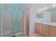 Bright bathroom featuring double sink vanity and glass enclosed shower at 13196 Se 86Th Cir, Summerfield, FL 34491