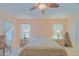 Bright bedroom featuring two windows, neutral walls, and carpet flooring at 13196 Se 86Th Cir, Summerfield, FL 34491
