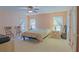 Cozy bedroom with natural light from two windows, complemented by bedside tables and a comfortable chair at 13196 Se 86Th Cir, Summerfield, FL 34491