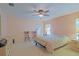 Bright bedroom with ample natural light, featuring neutral walls, carpet, and a cozy chair, perfect for relaxation at 13196 Se 86Th Cir, Summerfield, FL 34491