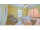 Bedroom featuring chair, side table and window with blinds at 13196 Se 86Th Cir, Summerfield, FL 34491