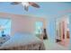 Spacious bedroom with ceiling fan, carpet, and ensuite bathroom entrance at 13196 Se 86Th Cir, Summerfield, FL 34491