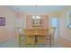 Formal dining room featuring a wooden table with decorative chairs and a glass-front hutch at 13196 Se 86Th Cir, Summerfield, FL 34491