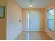 Inviting foyer with light wood flooring and a white front door with sidelight at 13196 Se 86Th Cir, Summerfield, FL 34491