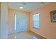 Bright foyer featuring wood flooring, a white front door with sidelight, and a window with blinds at 13196 Se 86Th Cir, Summerfield, FL 34491