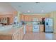 Spacious kitchen featuring wood cabinets, stainless steel appliances and open design at 13196 Se 86Th Cir, Summerfield, FL 34491