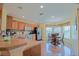 Well-lit kitchen with stainless steel appliances, wood cabinets, and a cozy breakfast nook with natural light at 13196 Se 86Th Cir, Summerfield, FL 34491