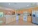 Spacious kitchen featuring wood cabinets, stainless steel appliances and open design at 13196 Se 86Th Cir, Summerfield, FL 34491