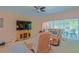Relaxing living room featuring leather recliners, a large TV, and views of the screened-in patio at 13196 Se 86Th Cir, Summerfield, FL 34491