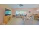 Comfortable living room featuring leather seating, a ceiling fan, and a cabinet with a TV at 13196 Se 86Th Cir, Summerfield, FL 34491