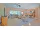 Cozy living room with leather furniture, ceiling fan, and sliding glass doors to the patio at 13196 Se 86Th Cir, Summerfield, FL 34491