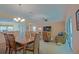Open-concept living room with dining area, featuring comfortable seating and view of outdoor space at 13196 Se 86Th Cir, Summerfield, FL 34491