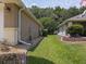 Well-maintained side yard featuring a manicured lawn, rock garden and mature trees, perfect for privacy at 13196 Se 86Th Cir, Summerfield, FL 34491
