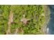 Aerial view of a home surrounded by lush trees and a pristine lake at 14620 Se 47Th Loop, Ocklawaha, FL 32179