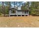 Charming one-story home with wood siding and a small porch surrounded by a wooded lot at 14620 Se 47Th Loop, Ocklawaha, FL 32179