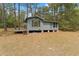 Charming one-story home with wood siding and a small porch surrounded by a wooded lot at 14620 Se 47Th Loop, Ocklawaha, FL 32179