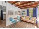 Cozy sunroom with wood ceiling, blue curtains, and seating, creating a relaxing indoor-outdoor space at 14620 Se 47Th Loop, Ocklawaha, FL 32179