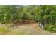 Tranquil outdoor setting with chairs and kayaks amid towering trees at 14620 Se 47Th Loop, Ocklawaha, FL 32179