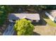 Charming single-story home with gray roof, mature trees, and expansive front yard at 16 Water Trak, Ocala, FL 34472