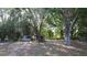 Large backyard featuring mature trees and a shed, offering ample outdoor space and potential for various activities at 16 Water Trak, Ocala, FL 34472