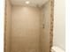 Tiled walk-in shower features tan tiles and decorative tiles on border at 16 Water Trak, Ocala, FL 34472