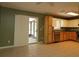 Open kitchen with tile floor and sliding door to screened porch at 16 Water Trak, Ocala, FL 34472