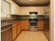 Spacious kitchen features stainless steel appliances, tile floor, and light wood cabinets at 16 Water Trak, Ocala, FL 34472