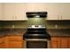 Traditional-style kitchen with black appliances, neutral countertops, and upper and lower wood cabinets at 16 Water Trak, Ocala, FL 34472