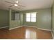 Bright, empty living room featuring hardwood floors and a ceiling fan at 16 Water Trak, Ocala, FL 34472