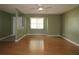 Bright, empty living room featuring hardwood floors and a ceiling fan at 16 Water Trak, Ocala, FL 34472