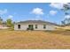 Home featuring a spacious backyard with a patio area and view of surrounding neighborhood at 16848 Sw 41St Avenue Rd, Ocala, FL 34473