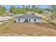 Home featuring a spacious backyard with a patio area and view of surrounding neighborhood at 16848 Sw 41St Avenue Rd, Ocala, FL 34473