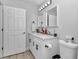 Bathroom features a double vanity with modern fixtures and white cabinets at 16848 Sw 41St Avenue Rd, Ocala, FL 34473