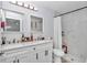 Bathroom features a double vanity, white cabinets, and a walk-in shower with glass door at 16848 Sw 41St Avenue Rd, Ocala, FL 34473