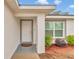 Exterior view of front door and front-facing windows with low maintenance landscaping at 16848 Sw 41St Avenue Rd, Ocala, FL 34473