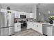 Stylish kitchen with stainless steel appliances, white cabinets and quartz countertops at 16848 Sw 41St Avenue Rd, Ocala, FL 34473