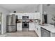 Modern kitchen features stainless steel appliances, white cabinetry and eat-in countertop at 16848 Sw 41St Avenue Rd, Ocala, FL 34473